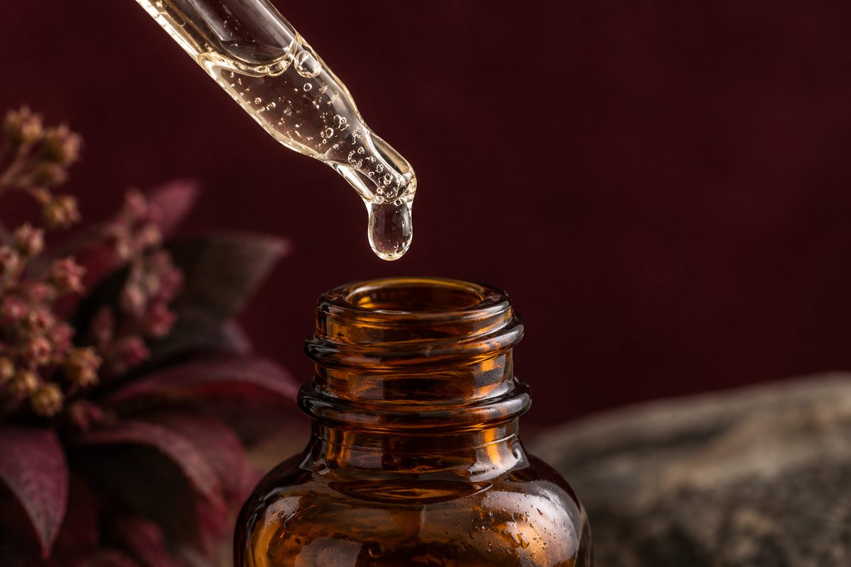 Amber dropper bottle dispensing viscous hyaluronic acid hydrating serum